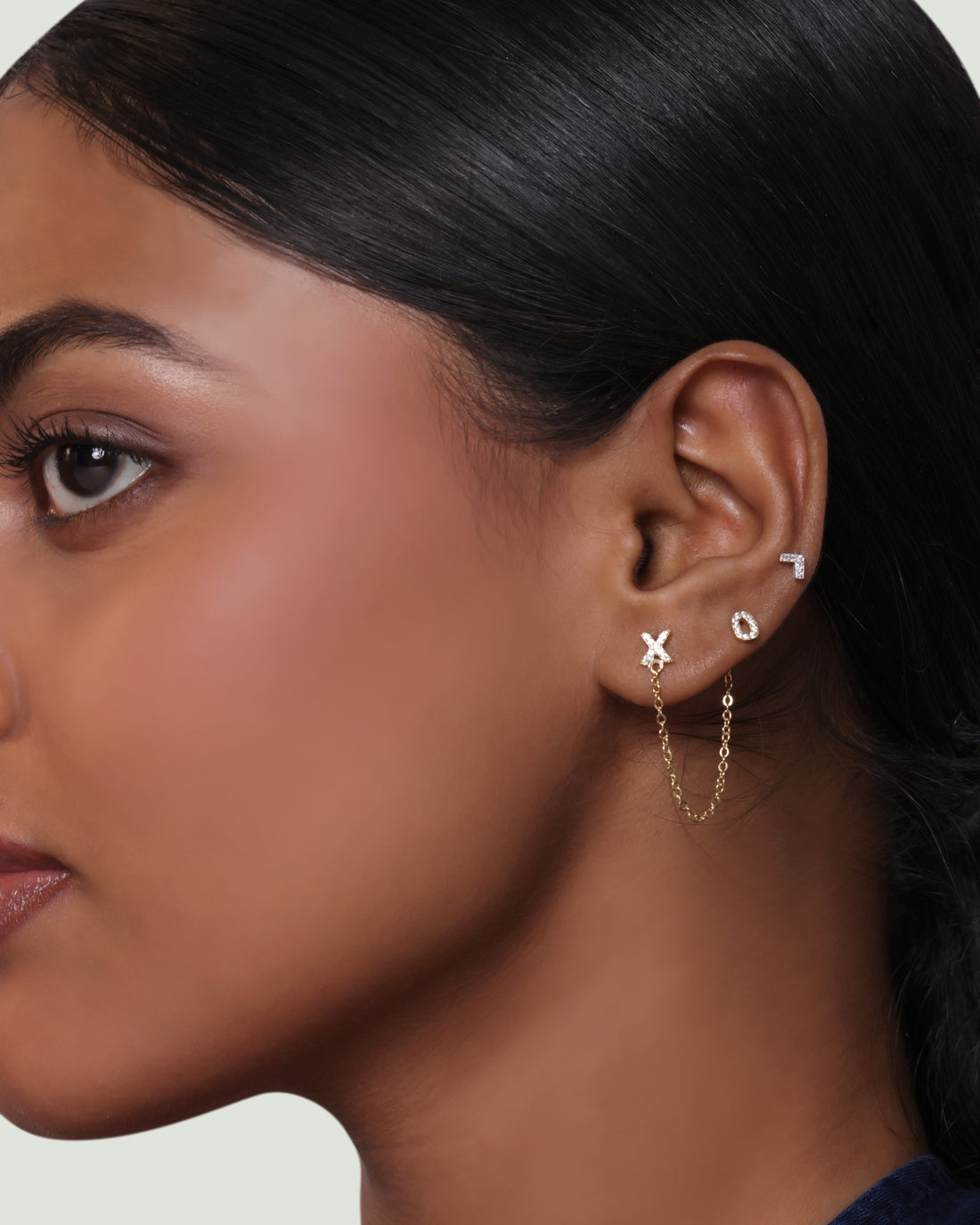 XO - Create 3 Chain Connector Earring in gold with pavé X and O studs linked by delicate chains, offering a multi-wear stud design.