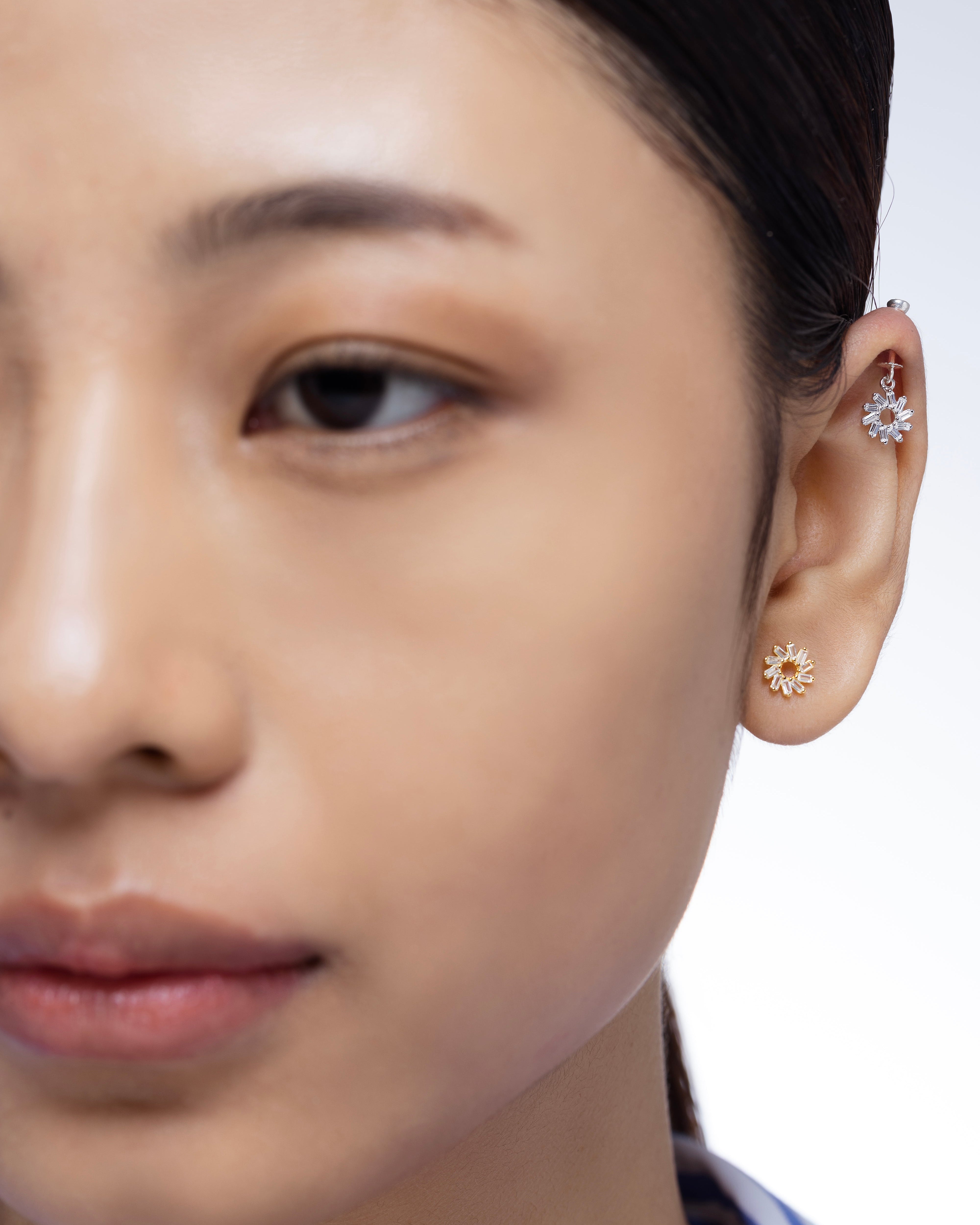 Model wearing Spiral Baguette Earrings - Snowflake Helix on helix piercing, showcasing iced ear accessory with elegant sterling silver sparkle.