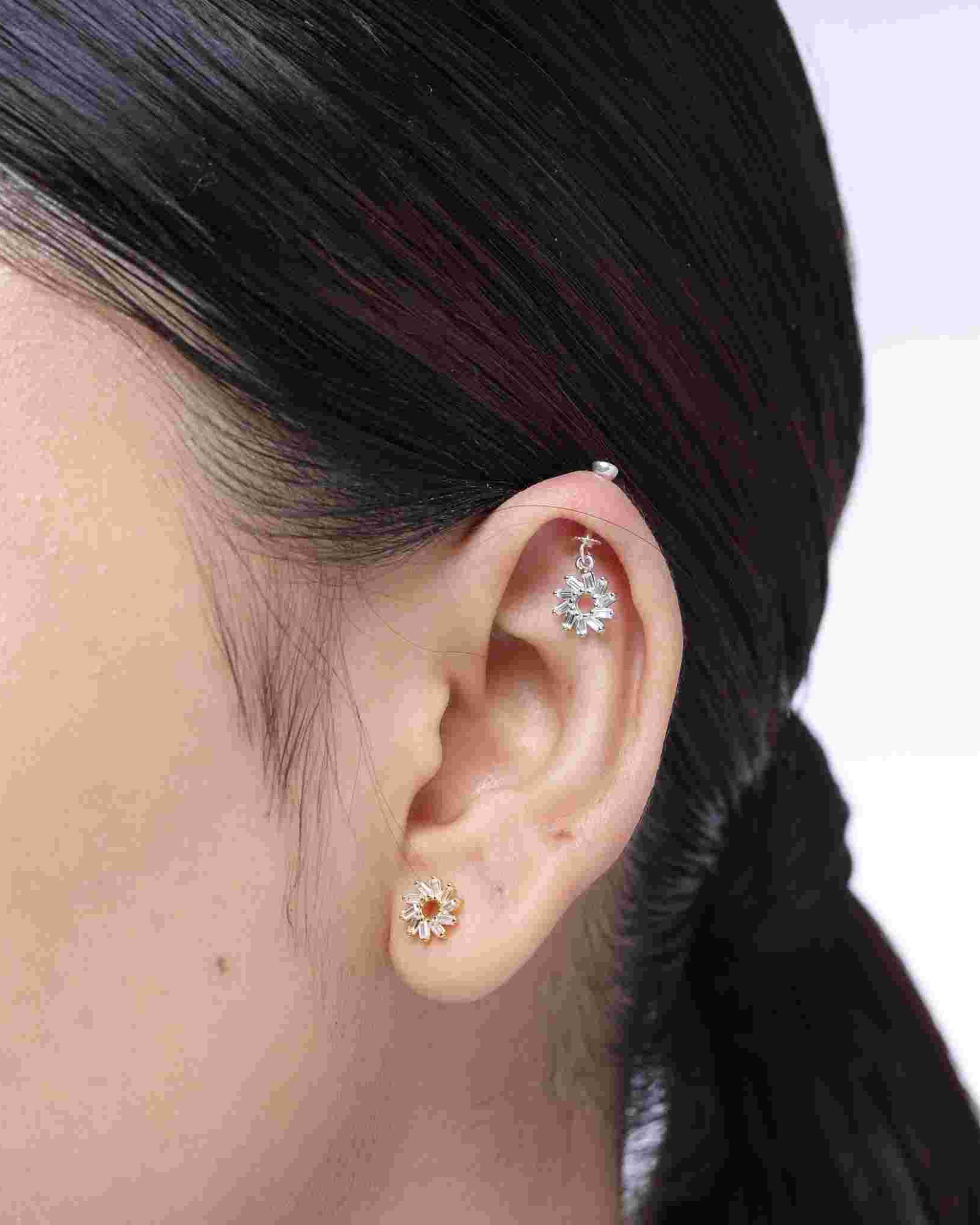 Close-up of Spiral Baguette Earrings - Snowflake Helix styled on ear, highlighting the shimmering snowflake design for a chic helix accessory look.