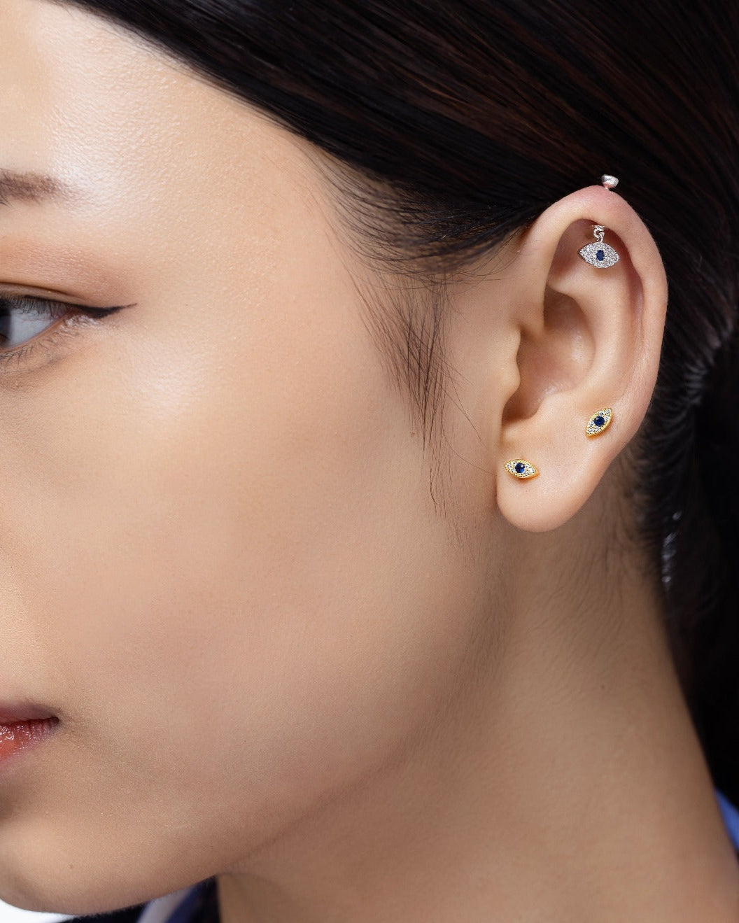 Zirconia Small Evil Eye Earrings - Versatile Style | Hanging Pair worn on helix piercing, highlighting their elegant and protective design in sterling silver.