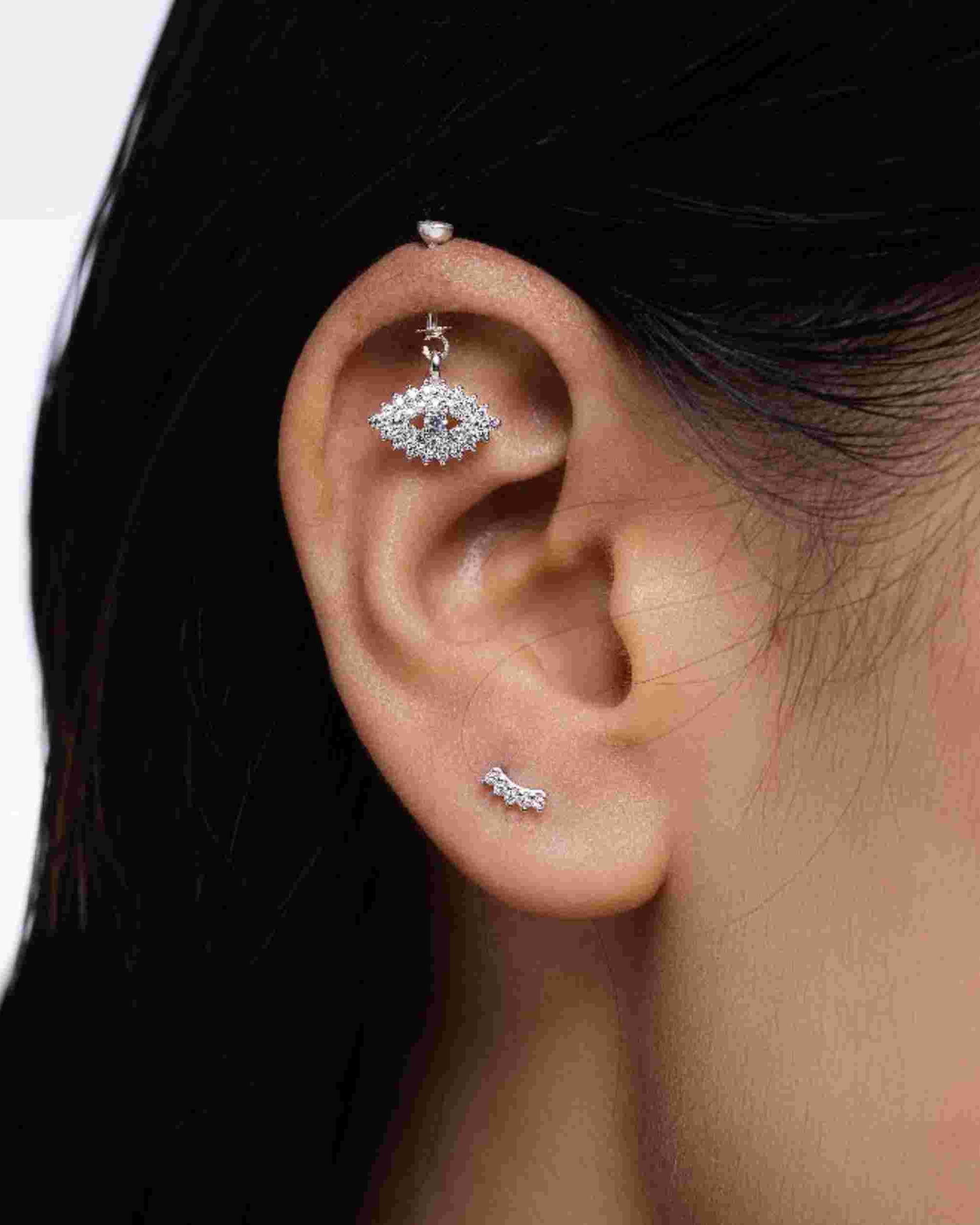 Luxury Helix Hanging earring worn on ear, showcasing screw top design and sparkling zircon eye charm. Perfect for stylish helix piercings.